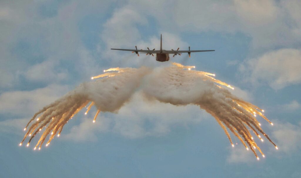 Airplane over Middle East symbolizing oil conflict